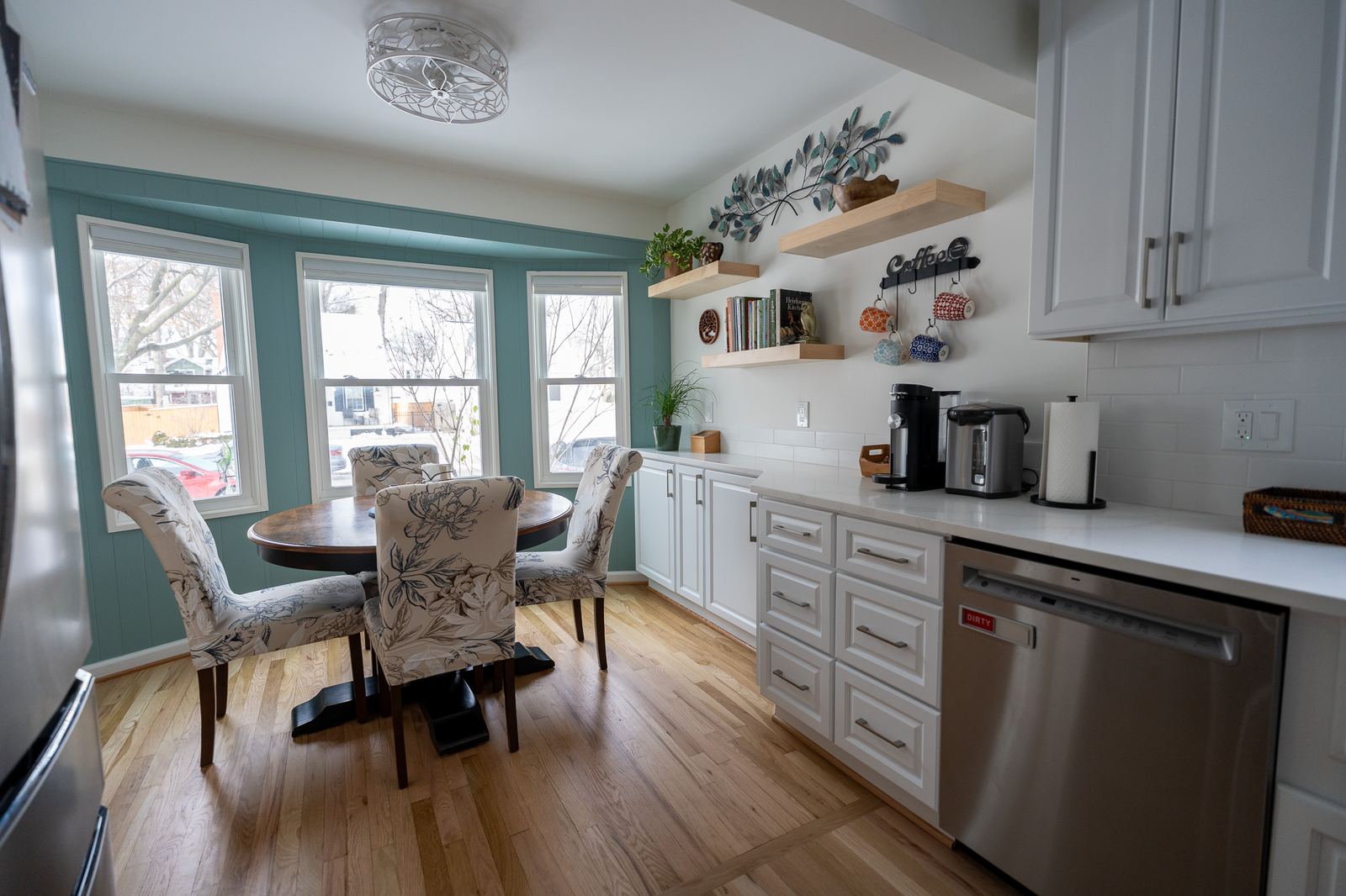 Bright custom kitchen with island and hardwood floors by Exclusive Home Build