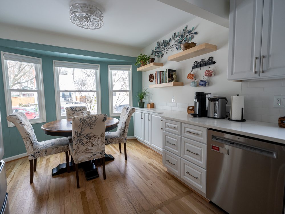 Breakfast nook with bay window, custom shelving and hardwood floors
